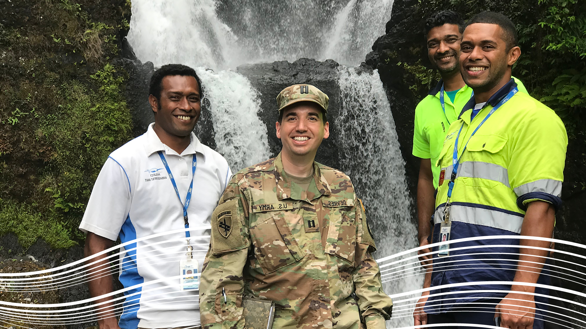 Gavin and friends in front of Fiji waterfall